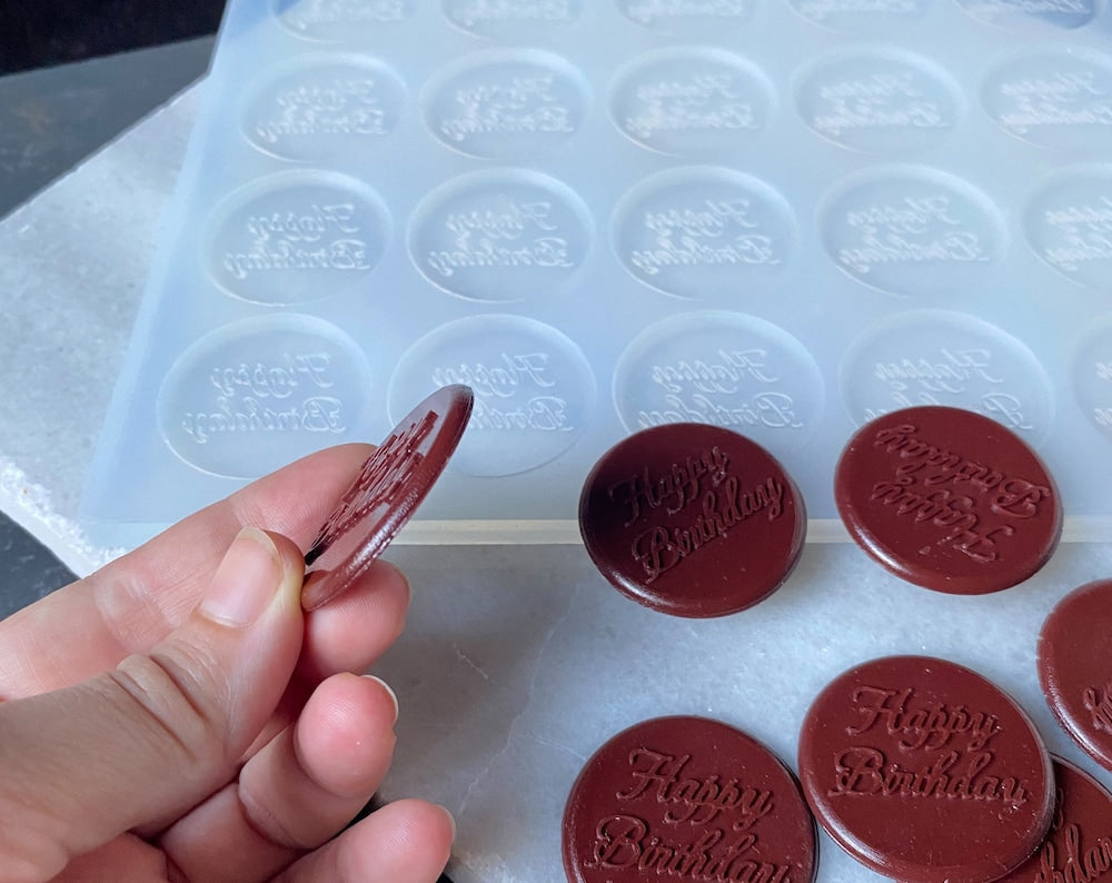 Create custom chocolates with this 24-cavity silicone mold. Food-grade, non-stick, and perfect for name toppers, cupcake designs & baking branding.